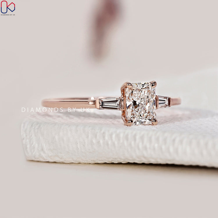 Tapered baguette diamond ring with a radiant cut centre diamond.
