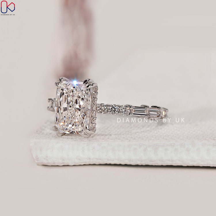 Round diamond rings with a pave set band and hidden halo.
