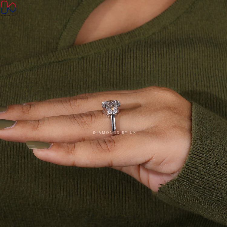 Diamondsbyuk engagement ring with half moon side diamonds.
