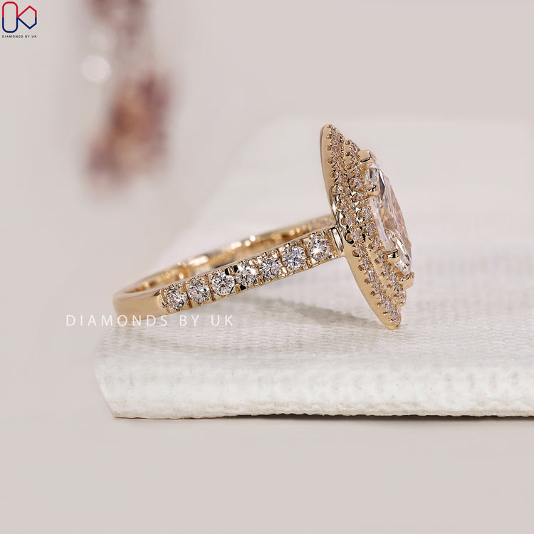 Halo round diamond engagement ring in yellow gold.
