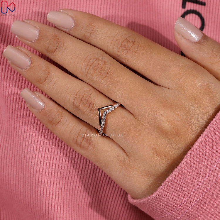 Rose gold wedding band with lab grown round diamonds.
