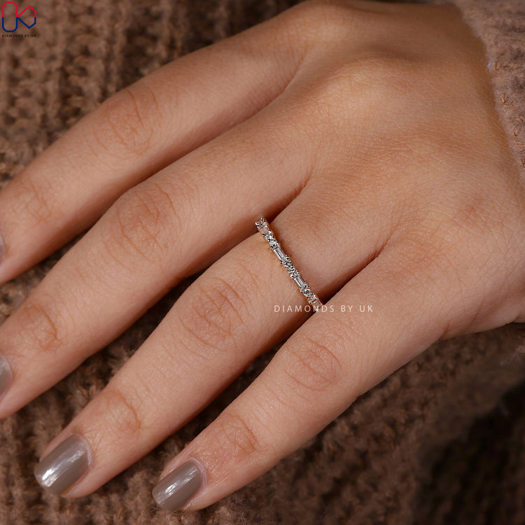 Prong setting wedding band highlighting each diamond.
