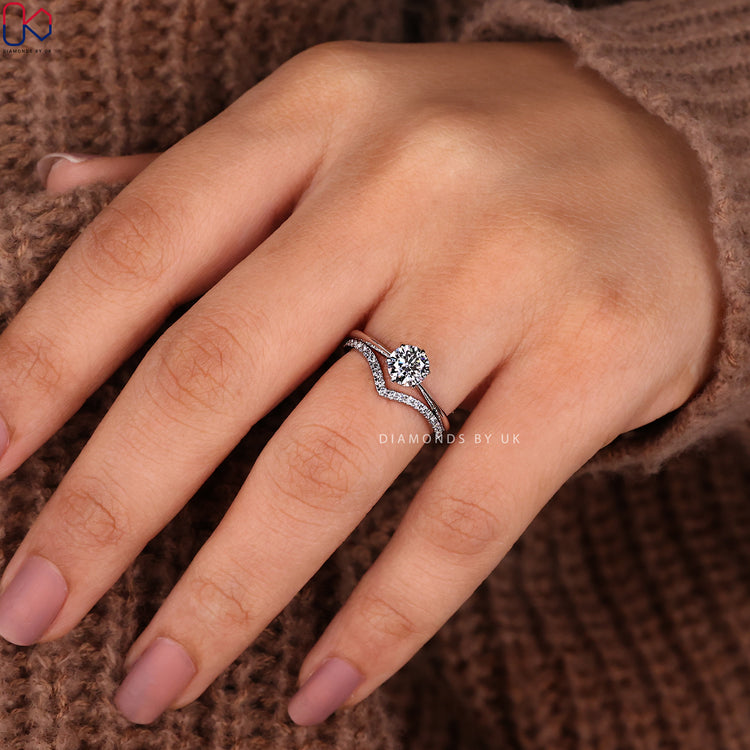 Curved diamond wedding band in a custom bridal set with round diamond ring.
