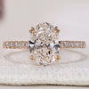 Oval diamond engagement ring with hidden halo design.
