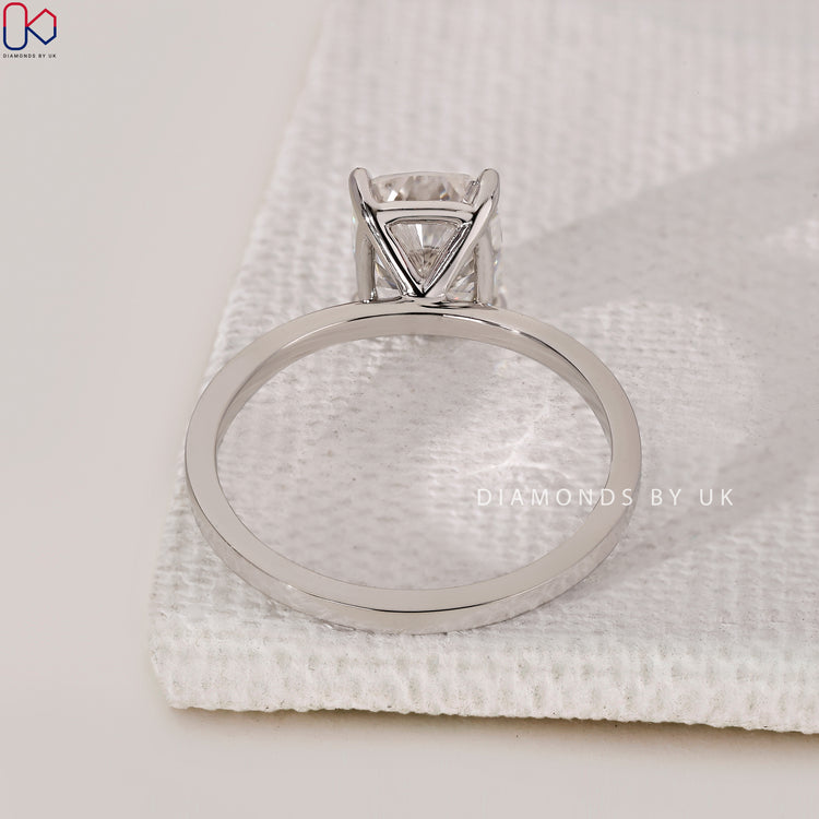Diamondsbyuk engagement ring in a white gold cushion cut solitaire setting for her.