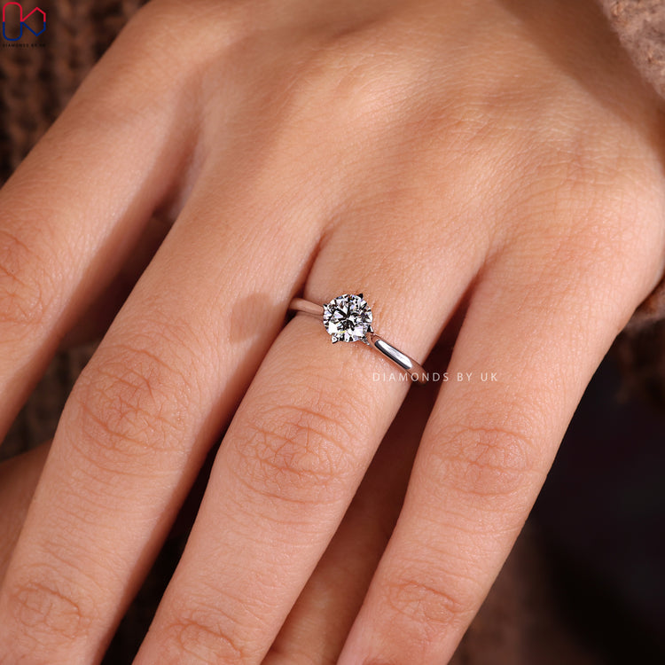 White gold engagement ring featuring compass prong setting.
