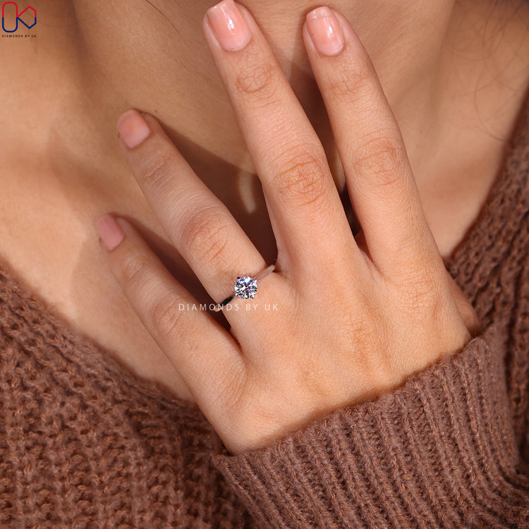 Round brilliant cut engagement ring with white gold band.
