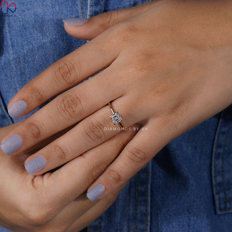 Custom Asscher cut ring in yellow gold with 4 prongs.