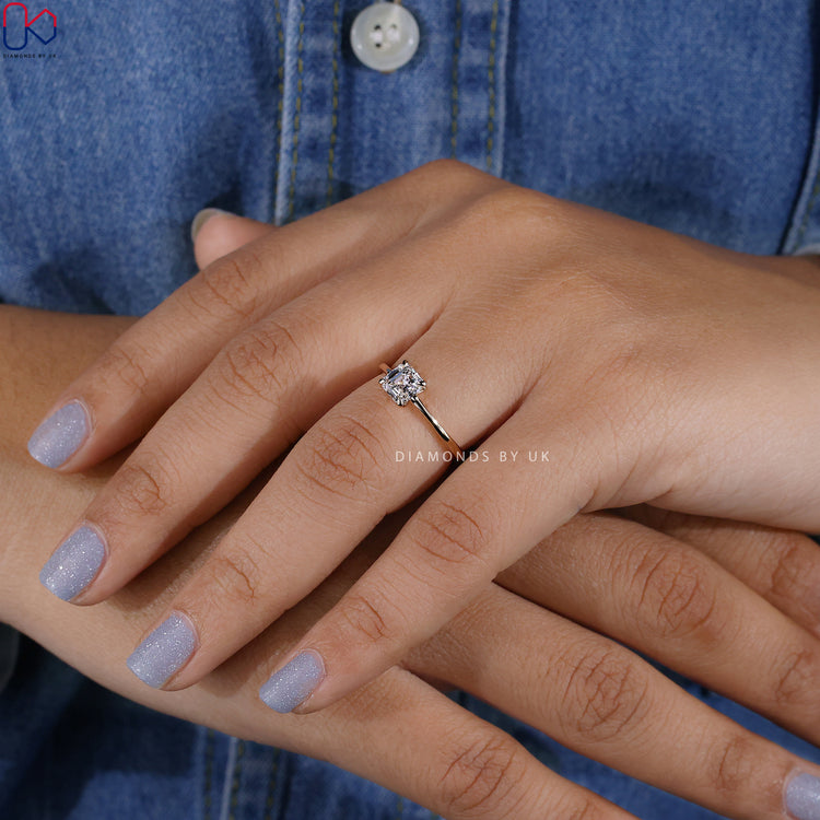 Elegant solitaire ring with Asscher cut center stone.