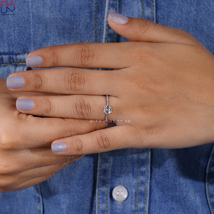 Prong set Asscher diamond ring with pave detail.