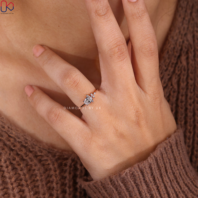 Rose gold engagement ring with a round diamond centerpiece.
