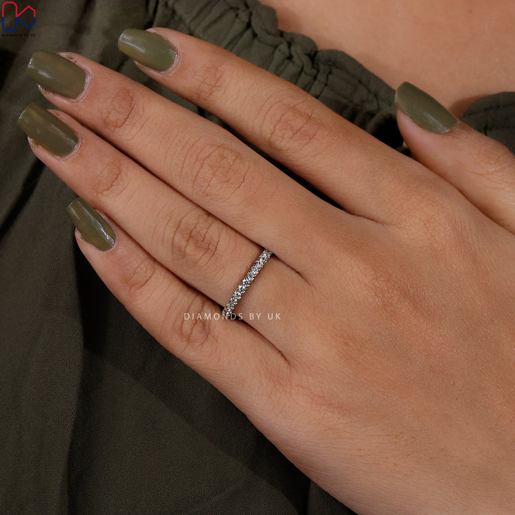 Handmade band with delicate round cut diamond accents.
