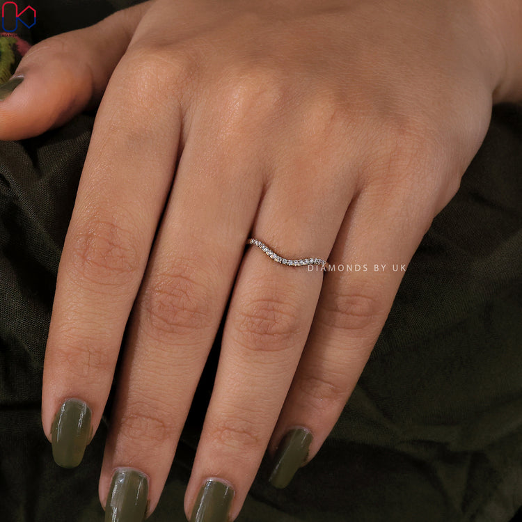 Buy diamond band in curved yellow gold from Diamondsbyuk.
