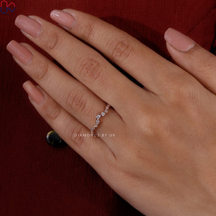 Round cut diamond band set in elegant rose gold.
