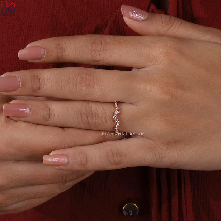 Handmade jewellery band featuring round cut diamonds in a curved design.
