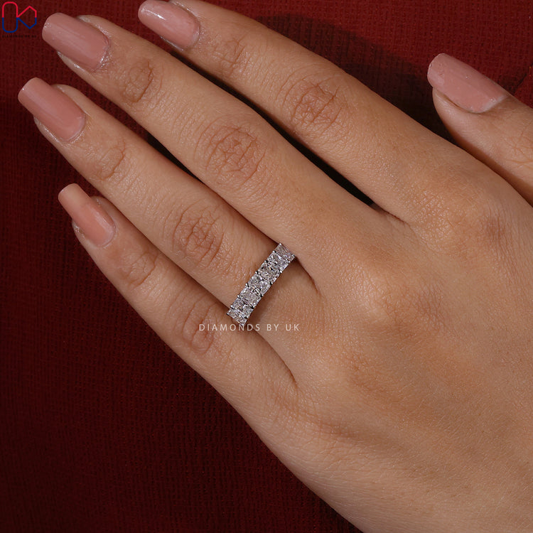 White gold wedding band featuring lab grown radiant cut diamonds.
