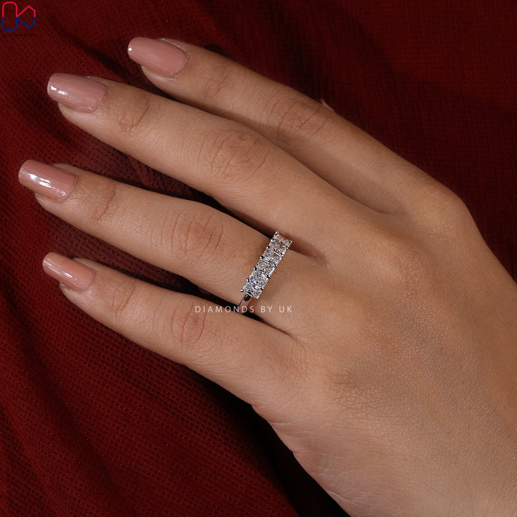 Half eternity diamond band featuring seven radiant cut stones.
