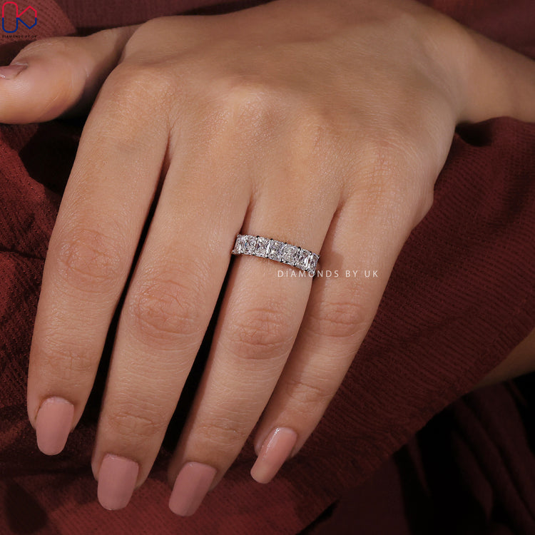 Elegant white gold 7 stone wedding band with radiant cut diamonds.
