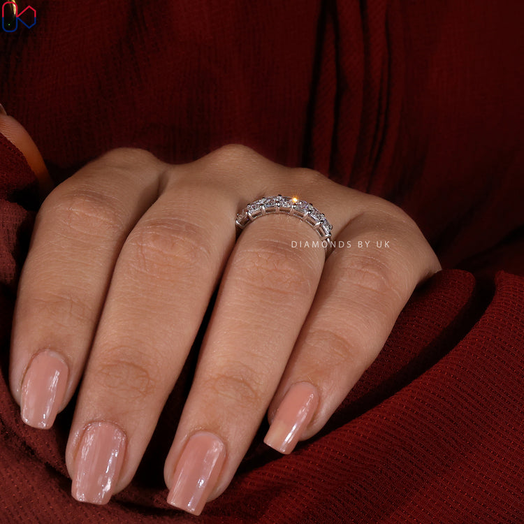 Lab grown diamond band with radiant cut stones set in a prong setting.
