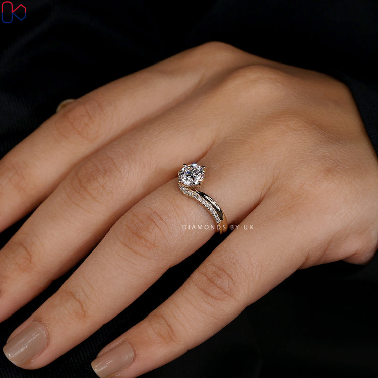 V-shaped engagement ring with a prong setting.

