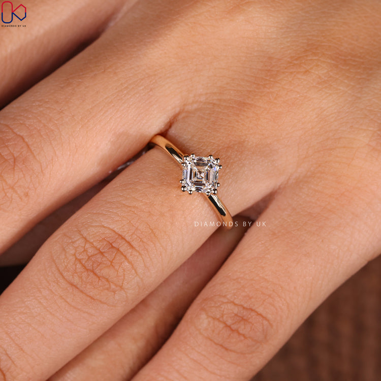 IGI certified asscher cut engagement ring with a yellow gold band.
