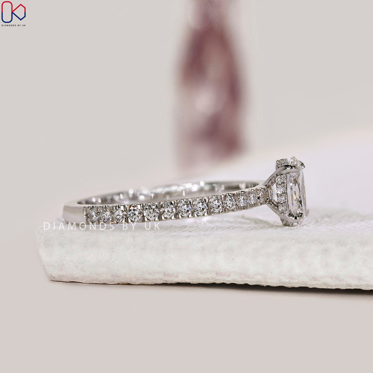 Oval diamond ring with pave setting and hidden halo.