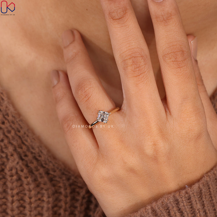 Buy engagement ring with asscher cut and yellow gold prong setting.
