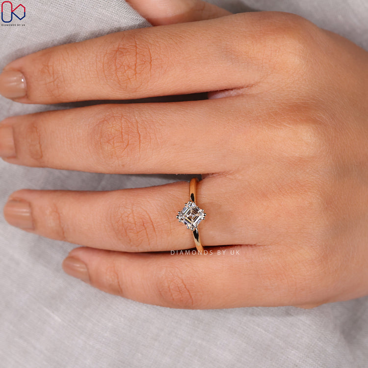 Handmade asscher cut ring with a prong setting in yellow gold.
