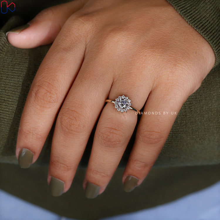 Yellow gold ring featuring round diamond and halo design.
