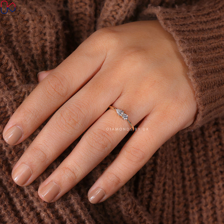 Prong setting ring with round and pear diamonds for a classic look.
