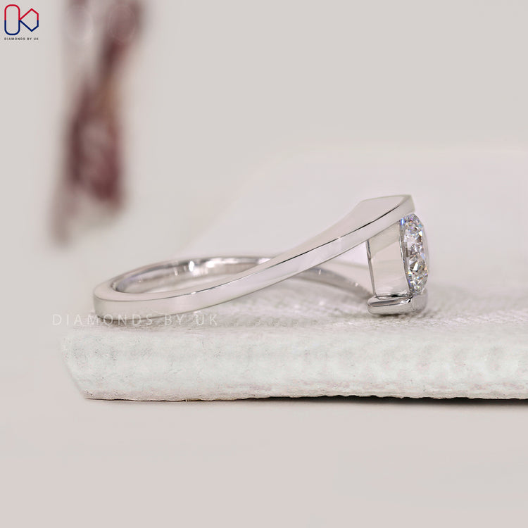 Elegant round diamond bypass engagement ring.
