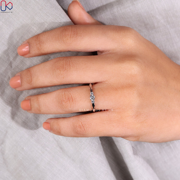 White gold ring showcasing a 3 stone round diamond.
