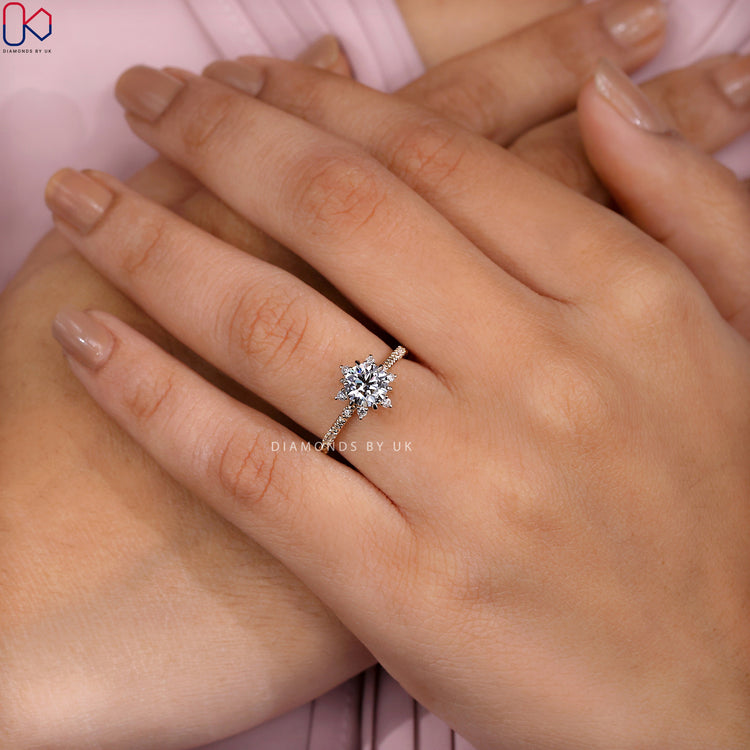 Cluster halo ring with pave detailing and a 6 prong claw setting.
