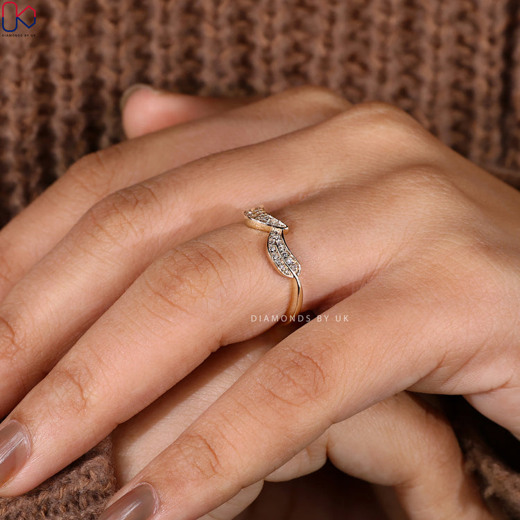 Diamondsbyuk engagement ring with round diamonds and yellow gold.