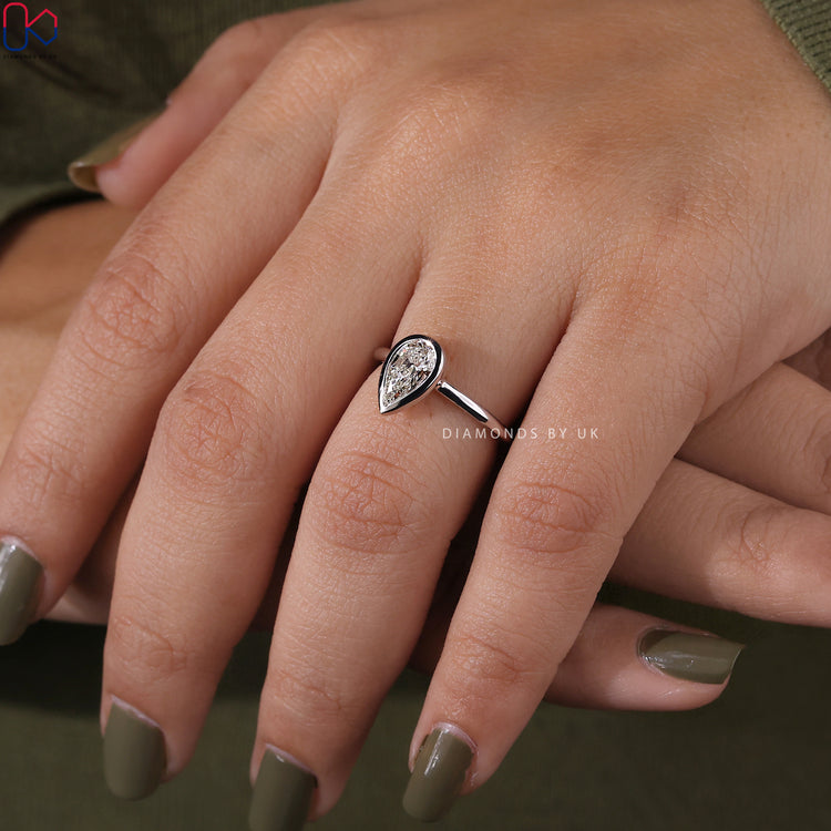 Handmade jewellery with pear cut diamond in bezel setting.
