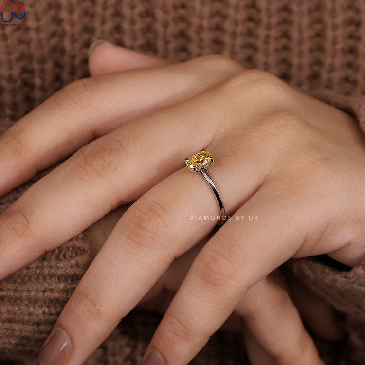 Handmade ring featuring a round canary yellow diamond.
