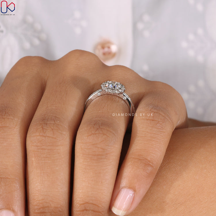 Pave setting ring featuring a round diamond in white gold.
