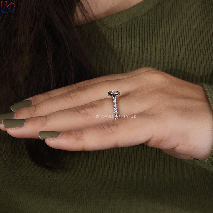 White gold engagement ring with round cut bezel diamond.
