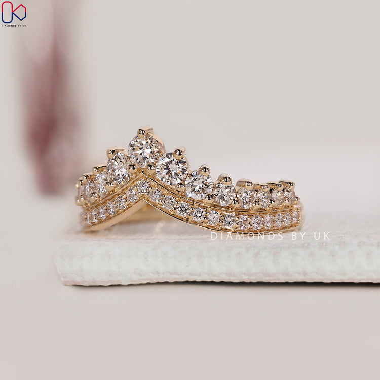 Chevron wedding band with double pave detail and curved profile.
