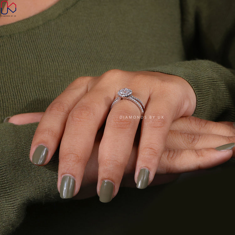 Double prong ring setting with a sparkling round diamond ring in a halo diamond engagement ring.