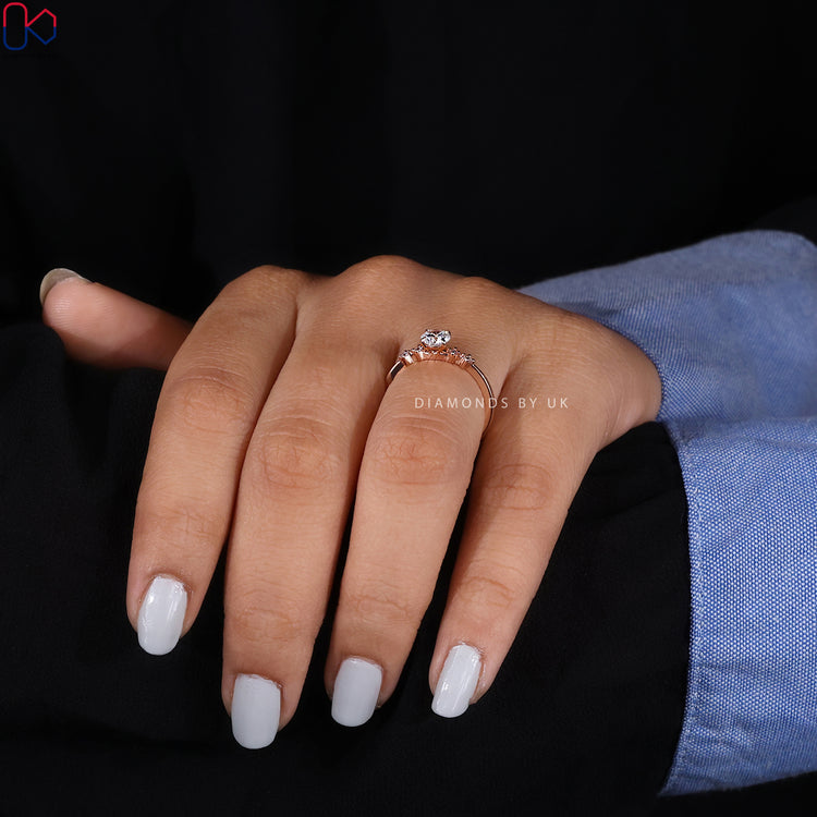 Tapered shank diamond ring with five round stones.
