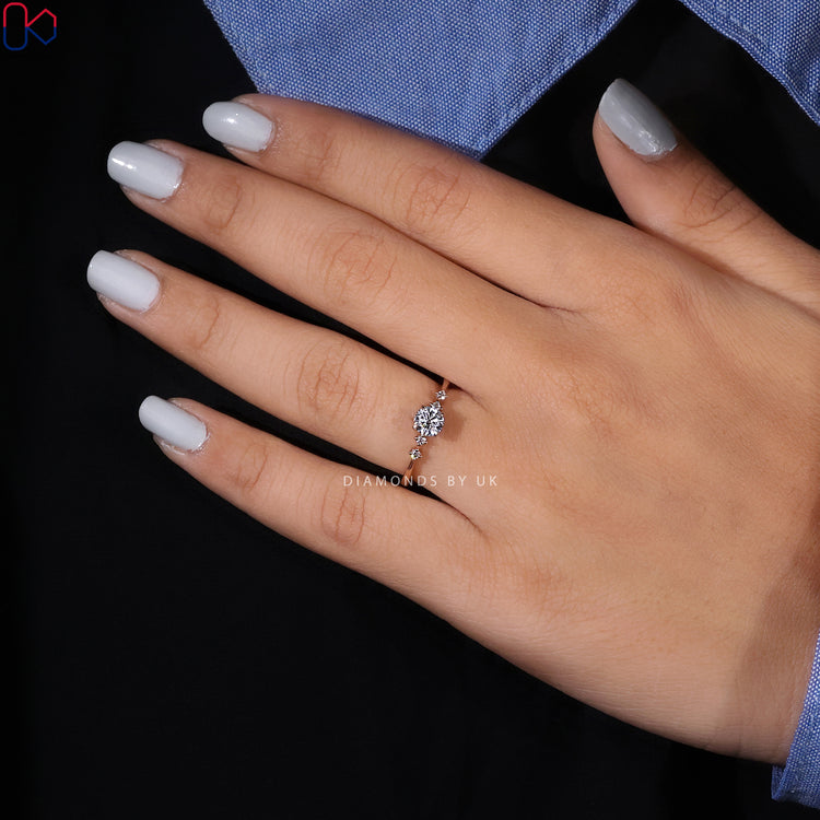 Round cut diamond ring with tapered band and five stones.
