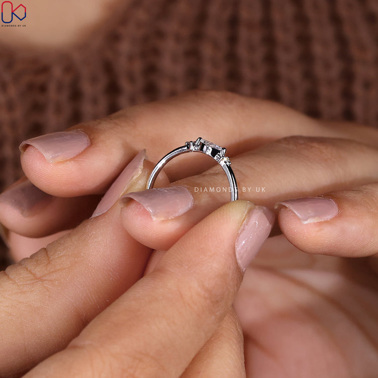 White gold band featuring a stunning 3 stone diamond setting.
