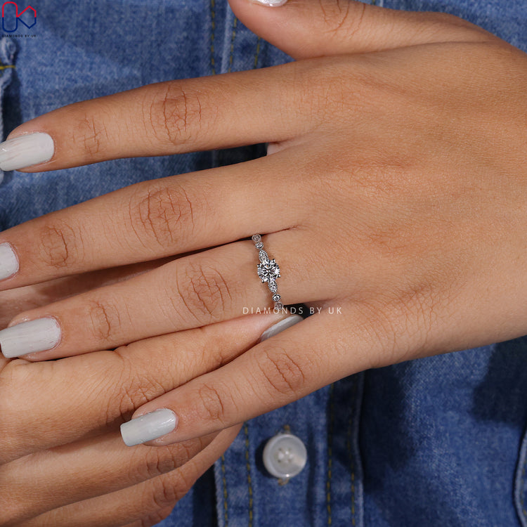 Elegant white gold engagement ring with round center stone.
