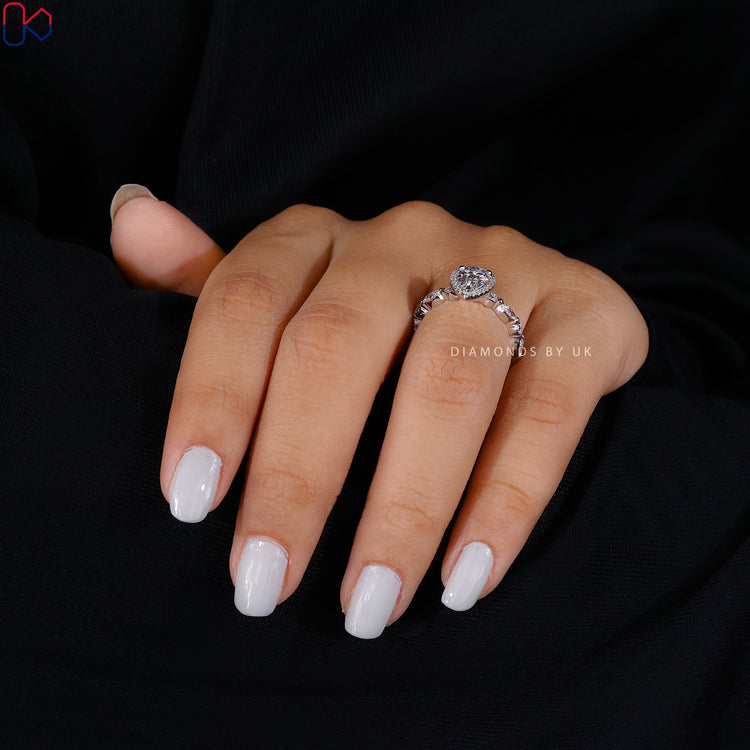 Buy engagement ring with halo and round side stones.
