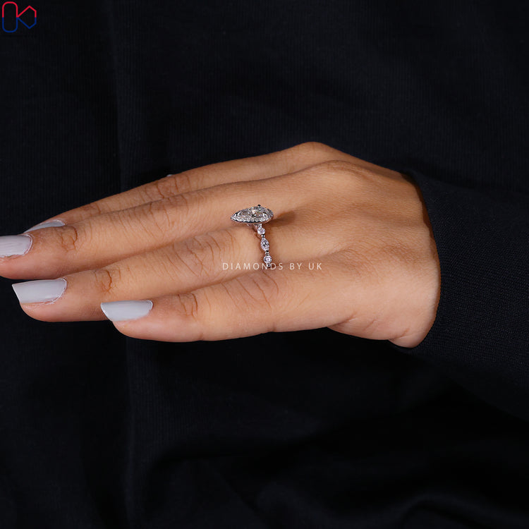 Lab grown diamond ring with pear shape and halo.
