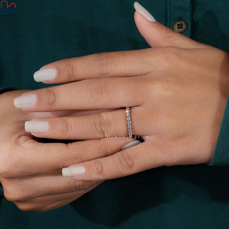 A radiant handmade jewelry piece featuring igi certified diamonds in a timeless wedding band style.
