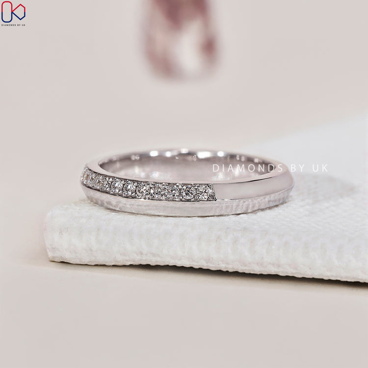 Sparkling pave wedding band featuring brilliant diamond accents.
