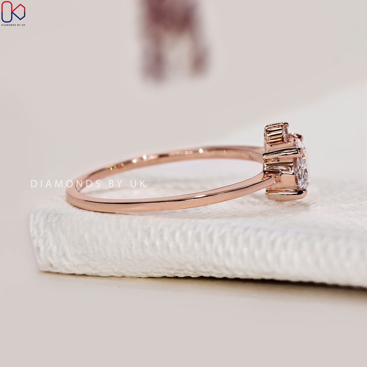 Round side stone engagement ring with a prong setting.
