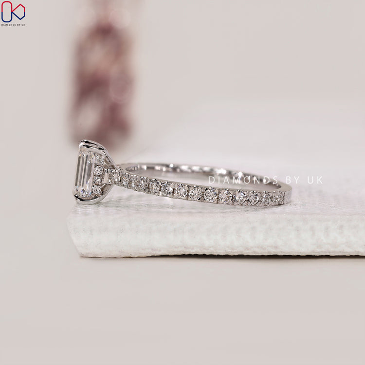 Pave band ring with emerald center diamond
